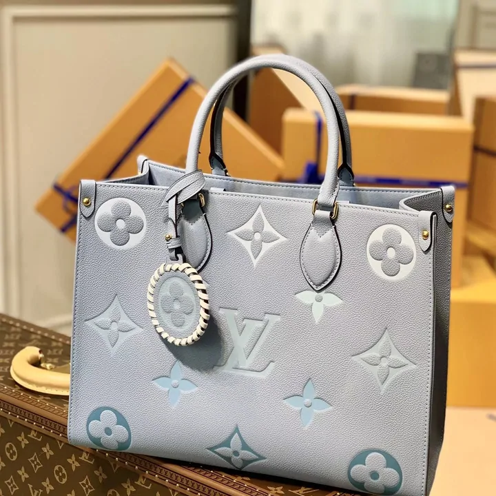 Pale grey monogram-embossed tote bag with twin handles