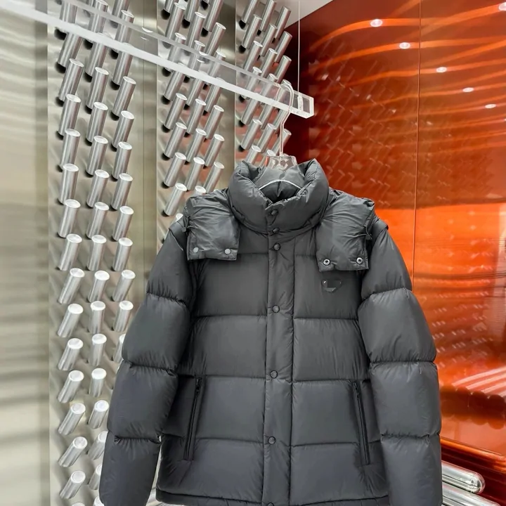 Black quilted puffer jacket on a hanger in front of a window blind